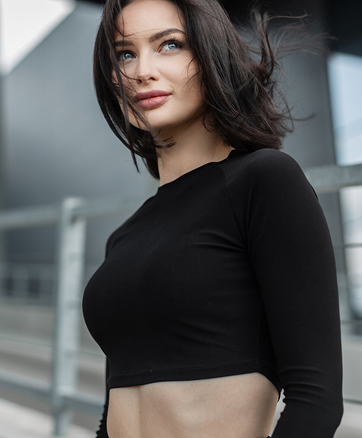 Woman in a black crop top outdoors.