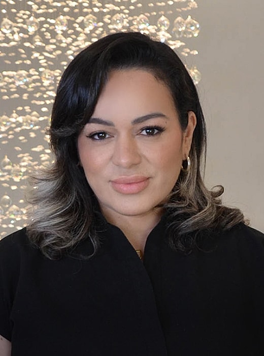 Woman with dark hair and soft curls.