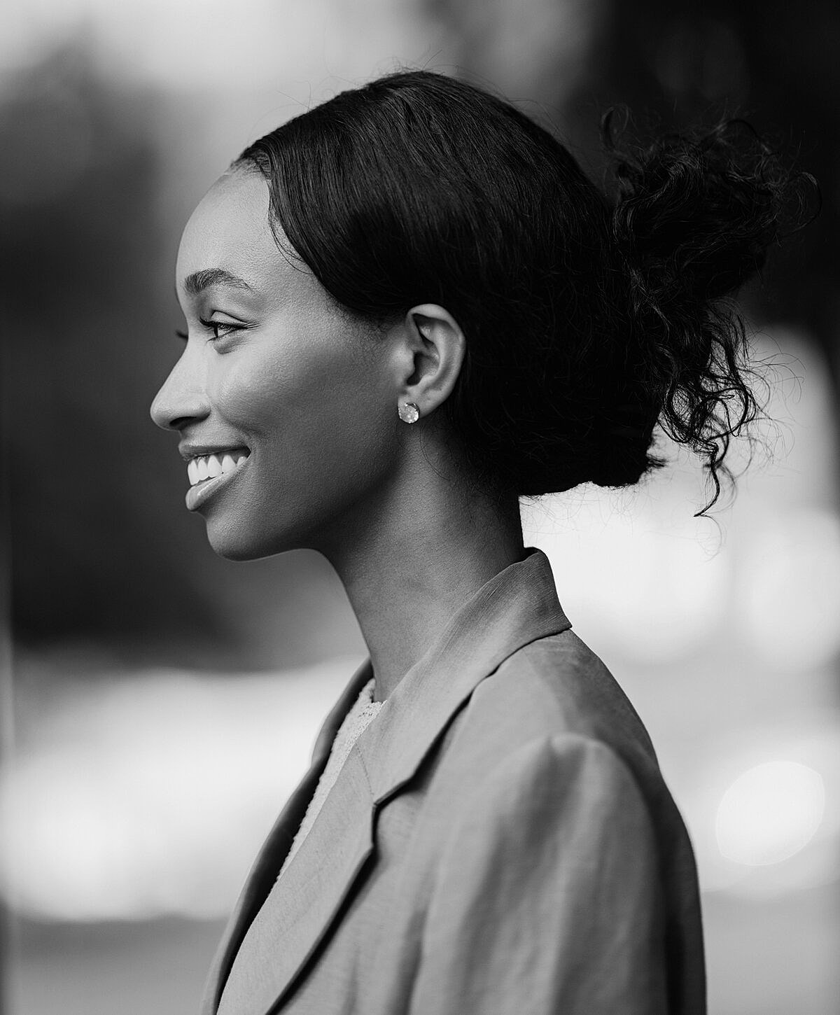 Profile portrait of a woman smiling elegantly.