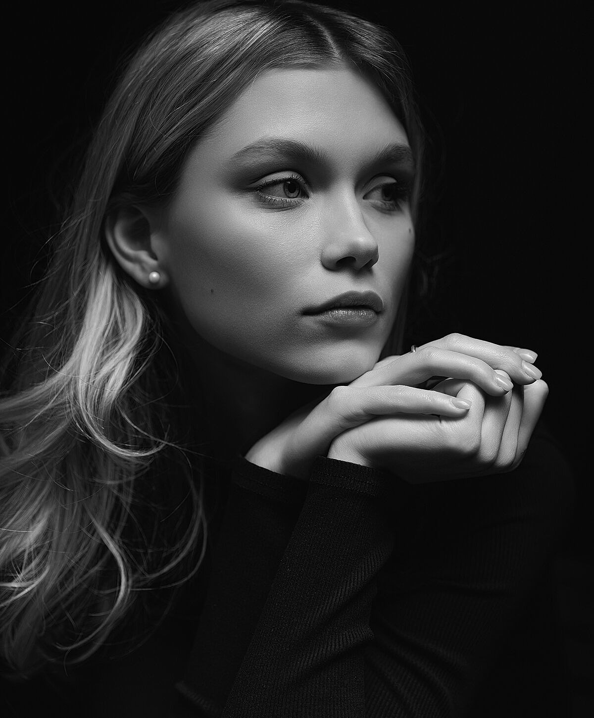Black and white portrait of a thoughtful young woman.