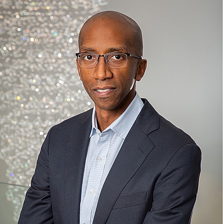 Professional man with glasses in business attire.