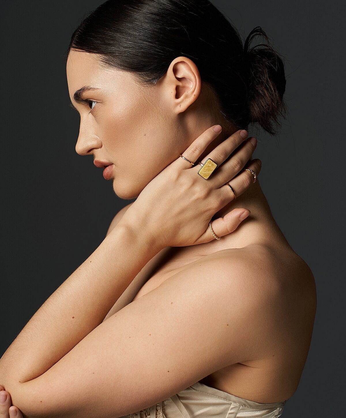 Model showing jewelry against a dark background.