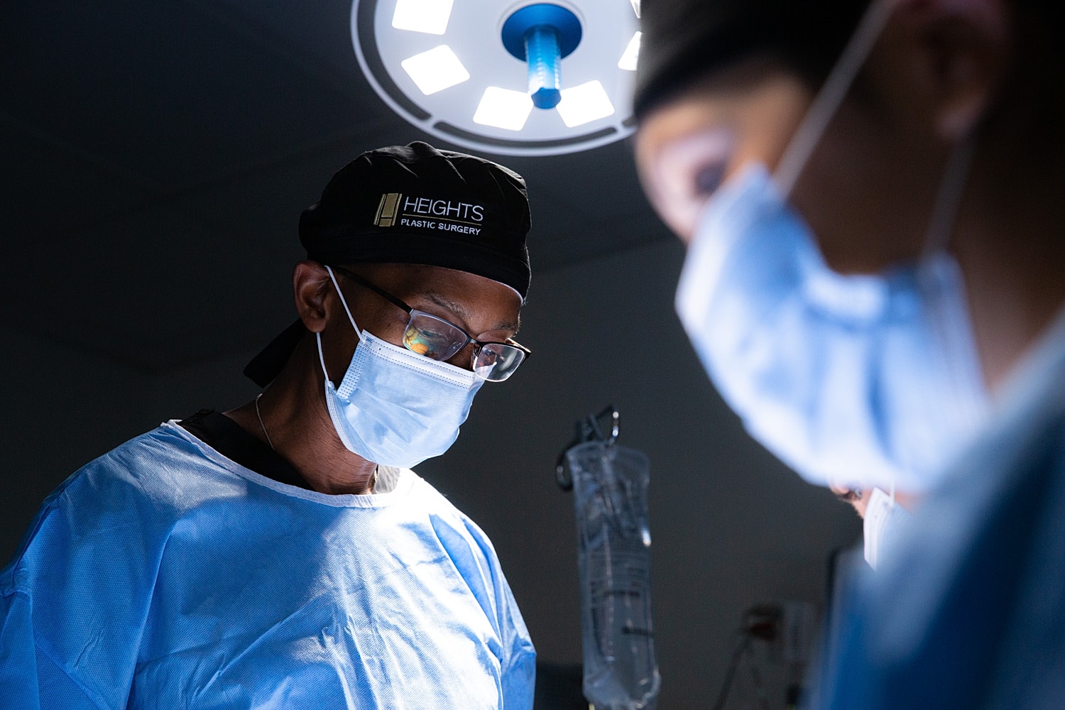 Surgeons performing surgery in operating room setting.