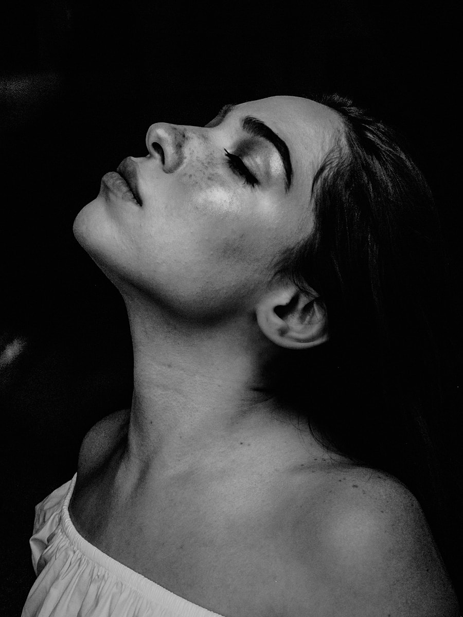 Black and white portrait of woman in profile.