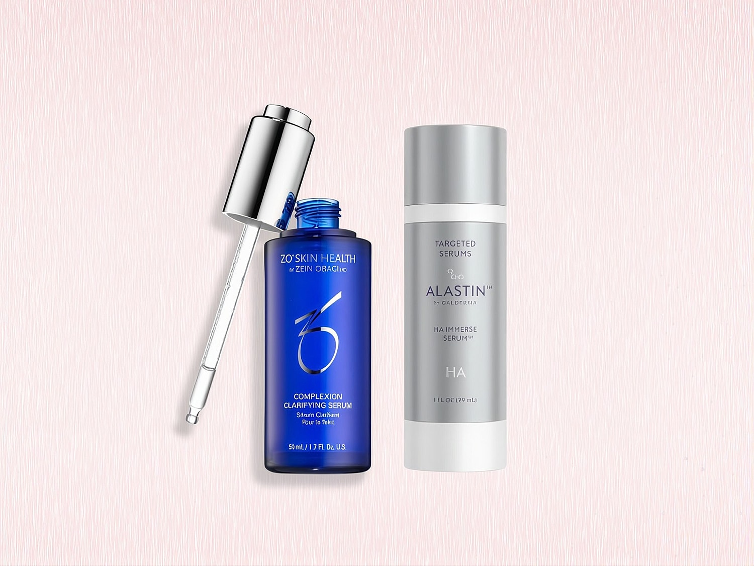 Two skincare serums on a textured background.