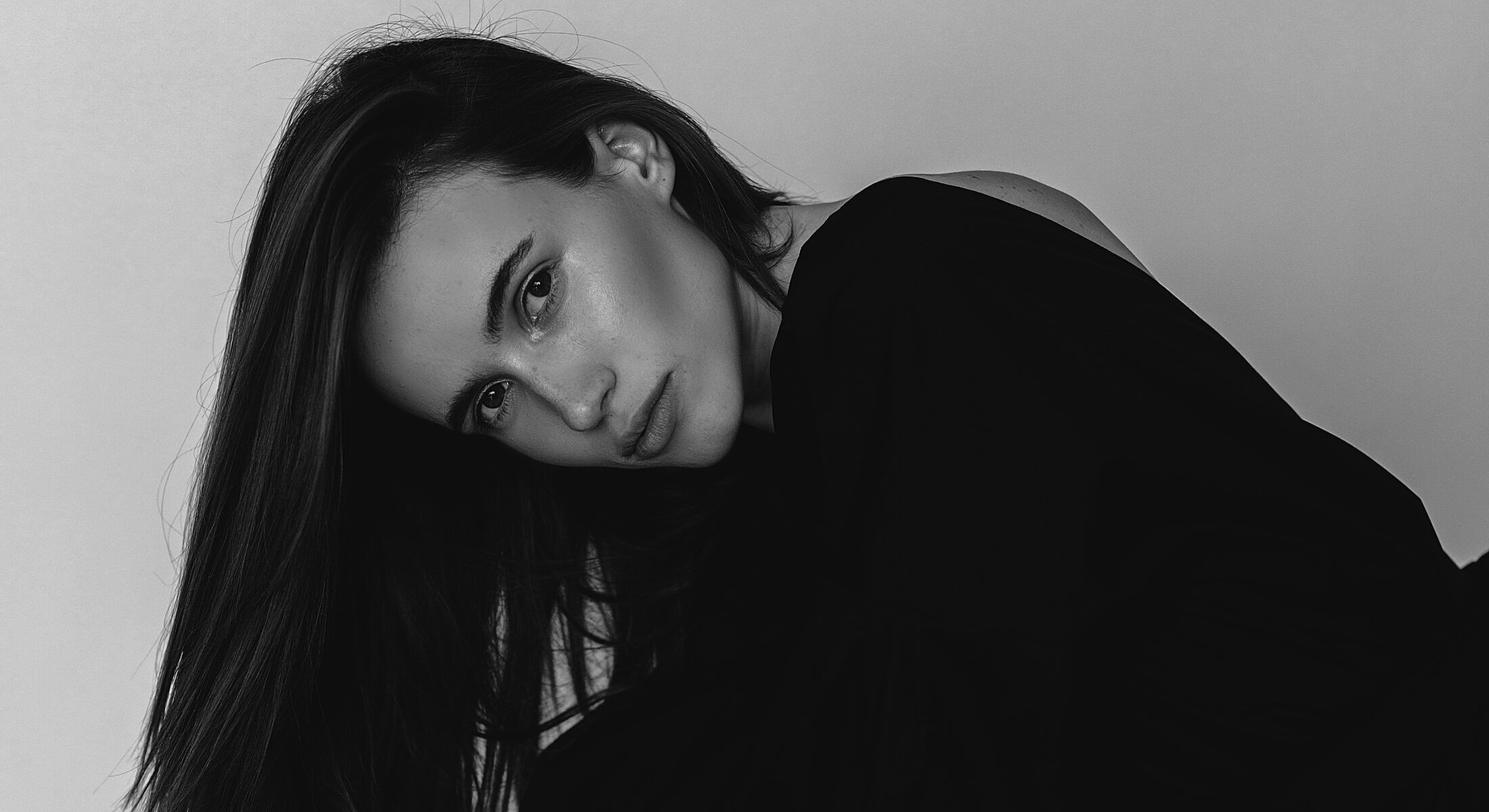 Black and white portrait of a thoughtful woman.