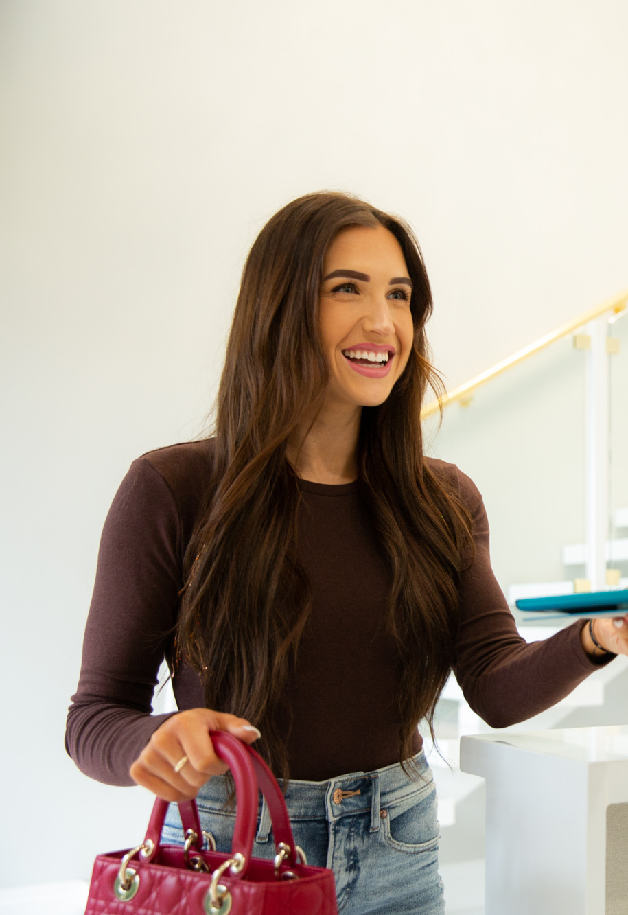 woman with brown hair and red purse